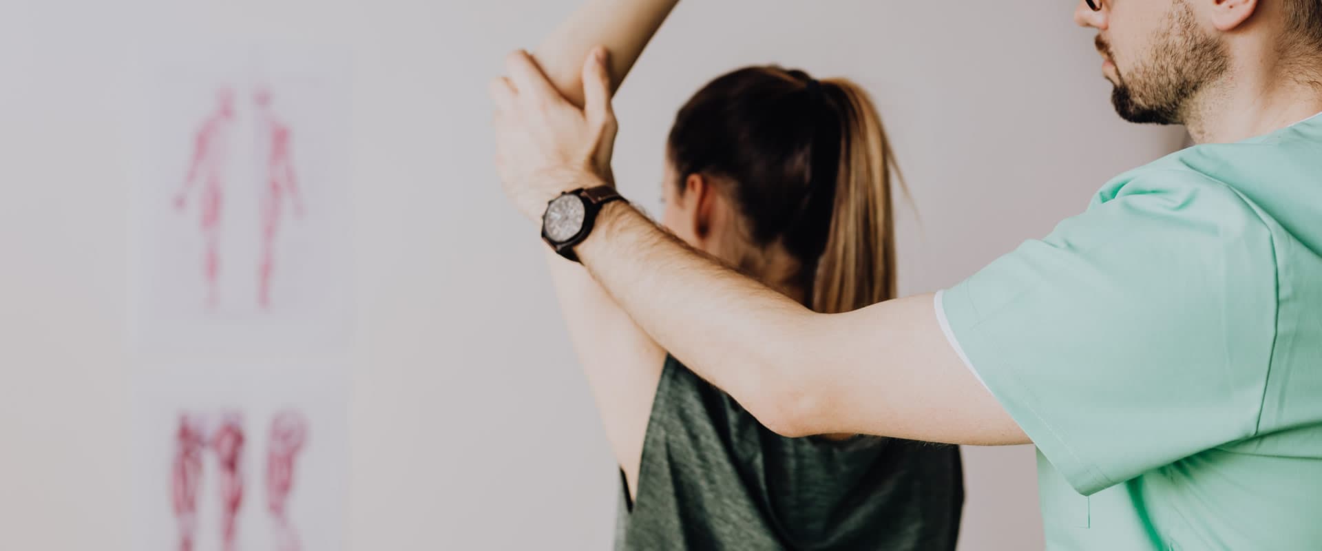 A therapist stretching a patient's arm