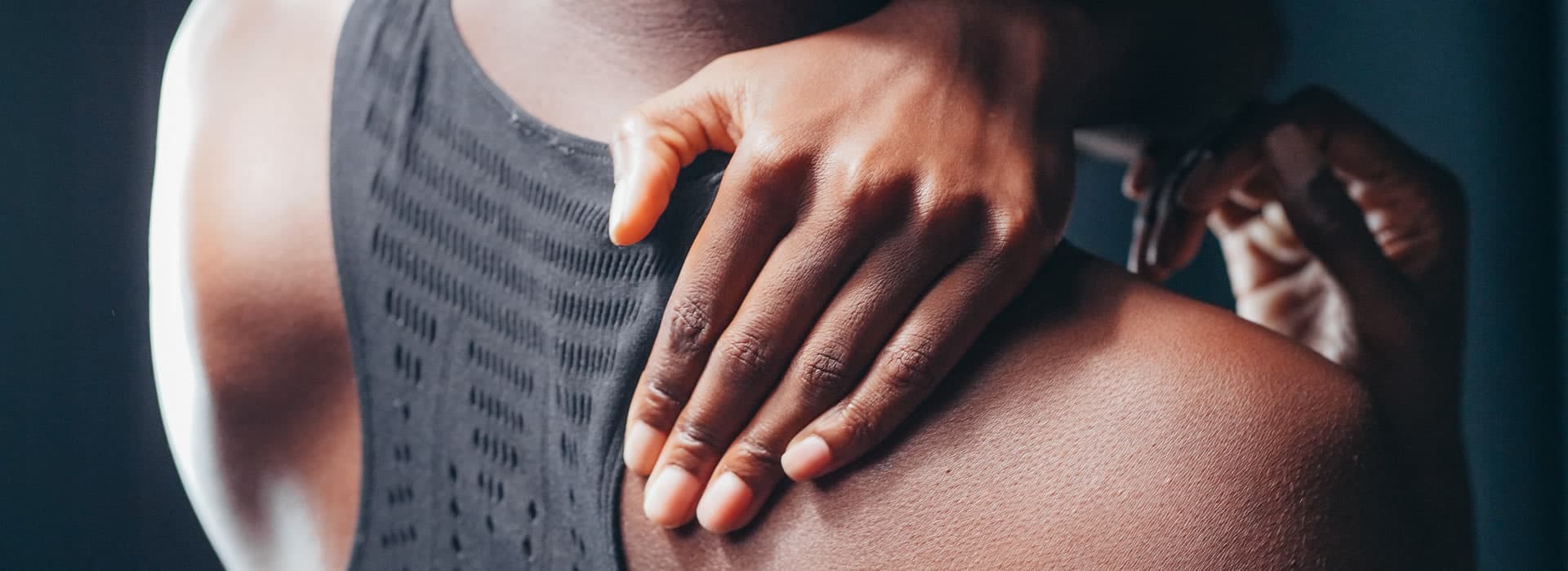 A therapist's hands on a patient's shoulder